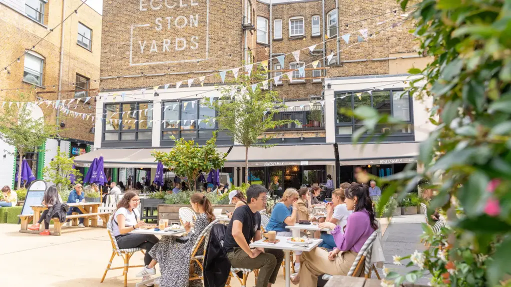 People dining outside in Eccleston Yards