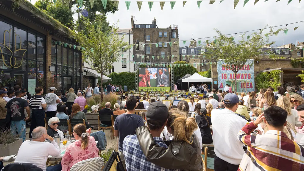 A crowd of people watch a movie in Eccleston Yards