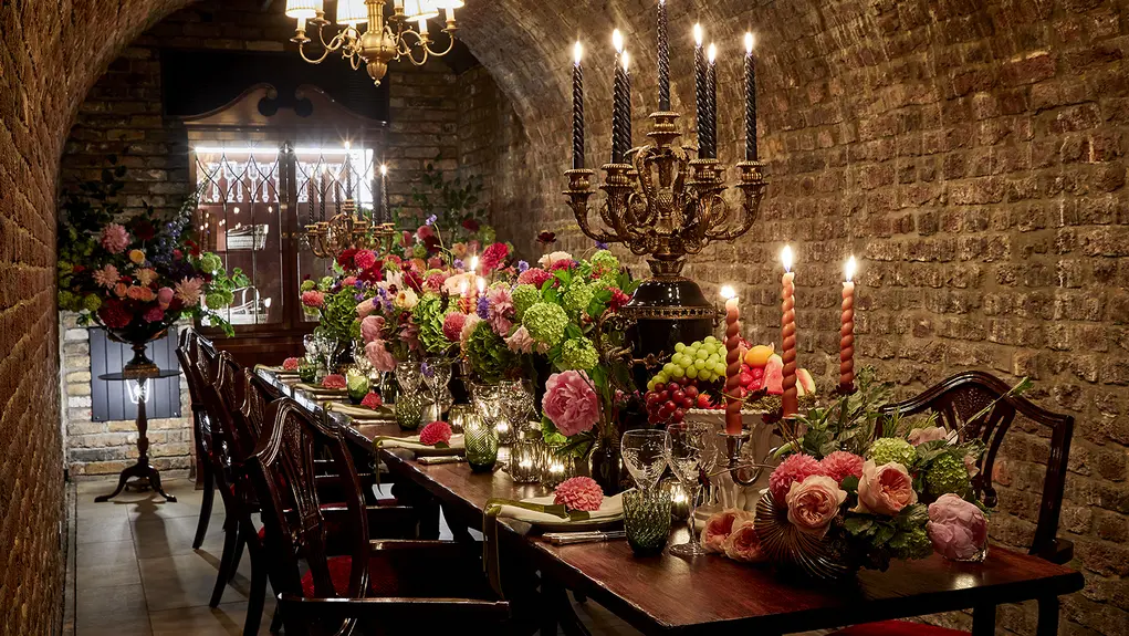 A long table filled with candles and flowers