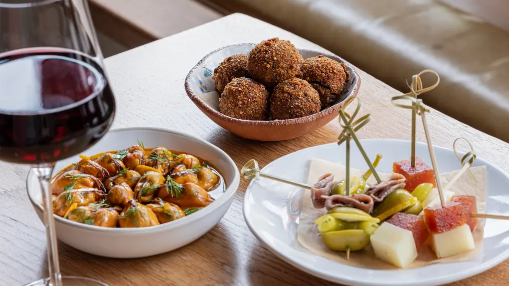 Bar snacks and a glass of red wine