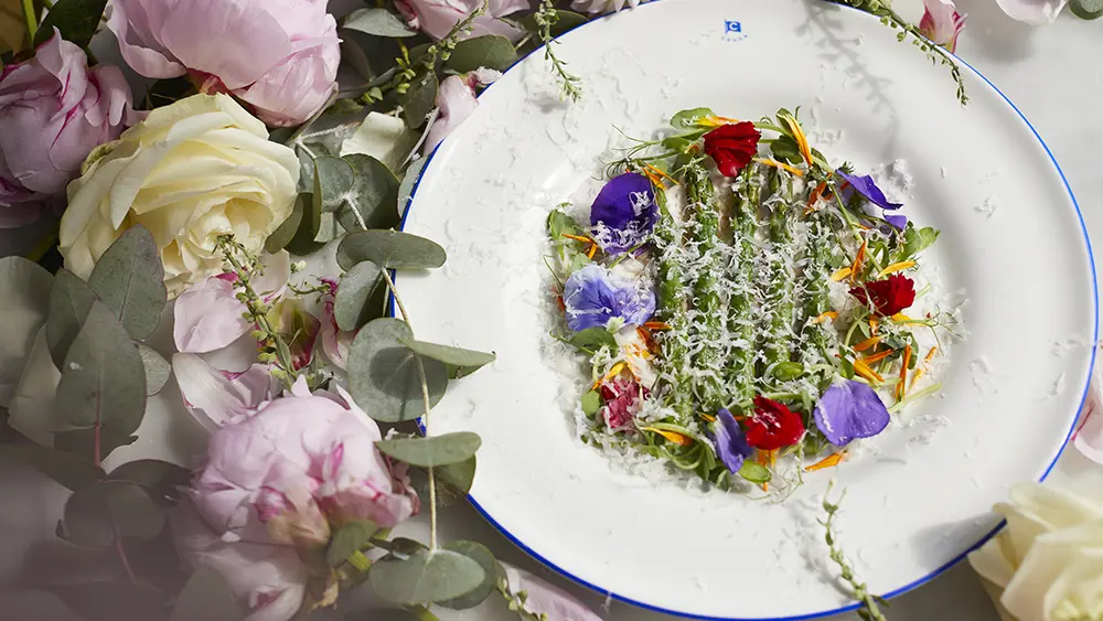 A plate of asparagus with flower decorations 