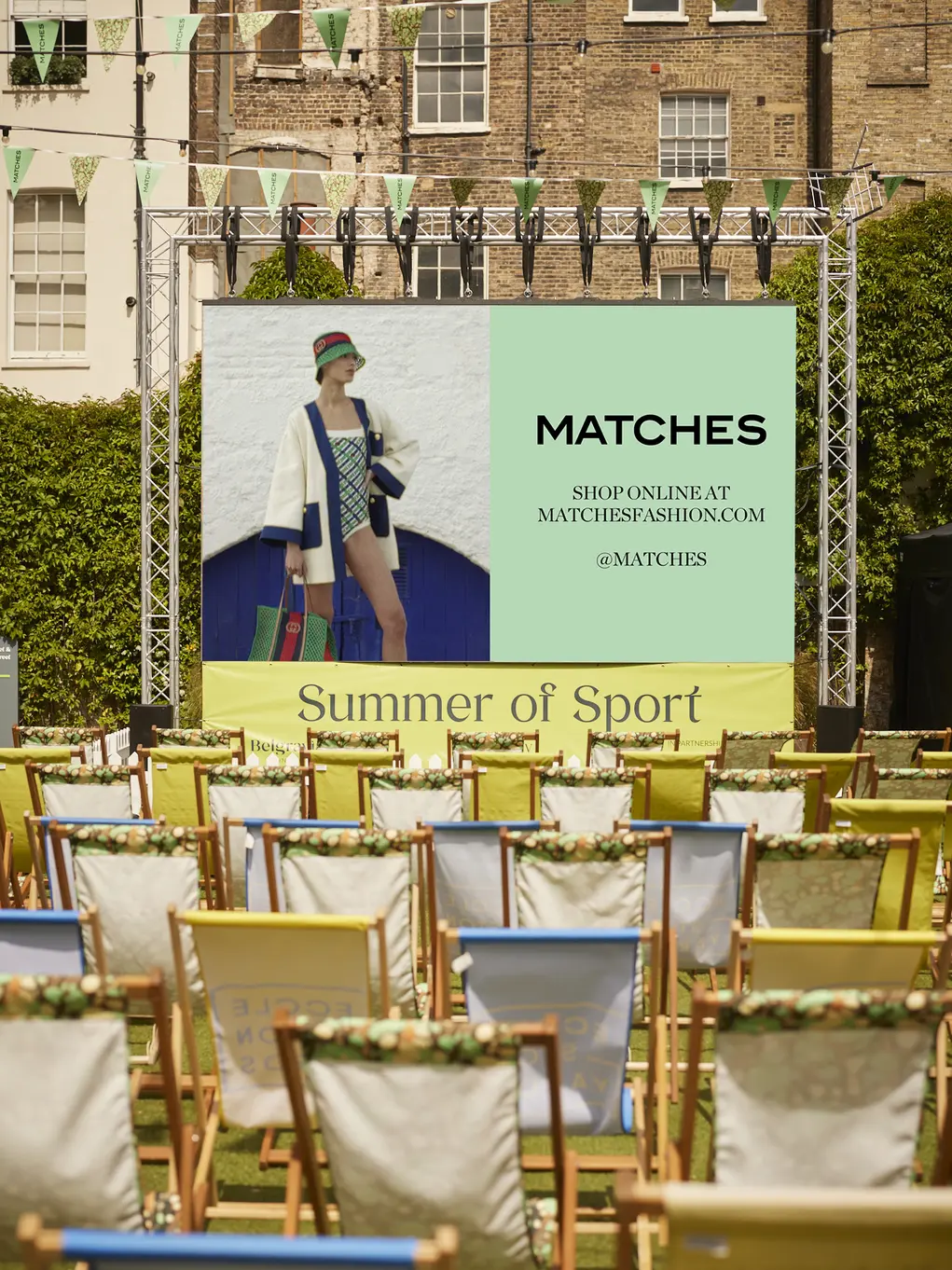 A big screen with deckchairs facing it
