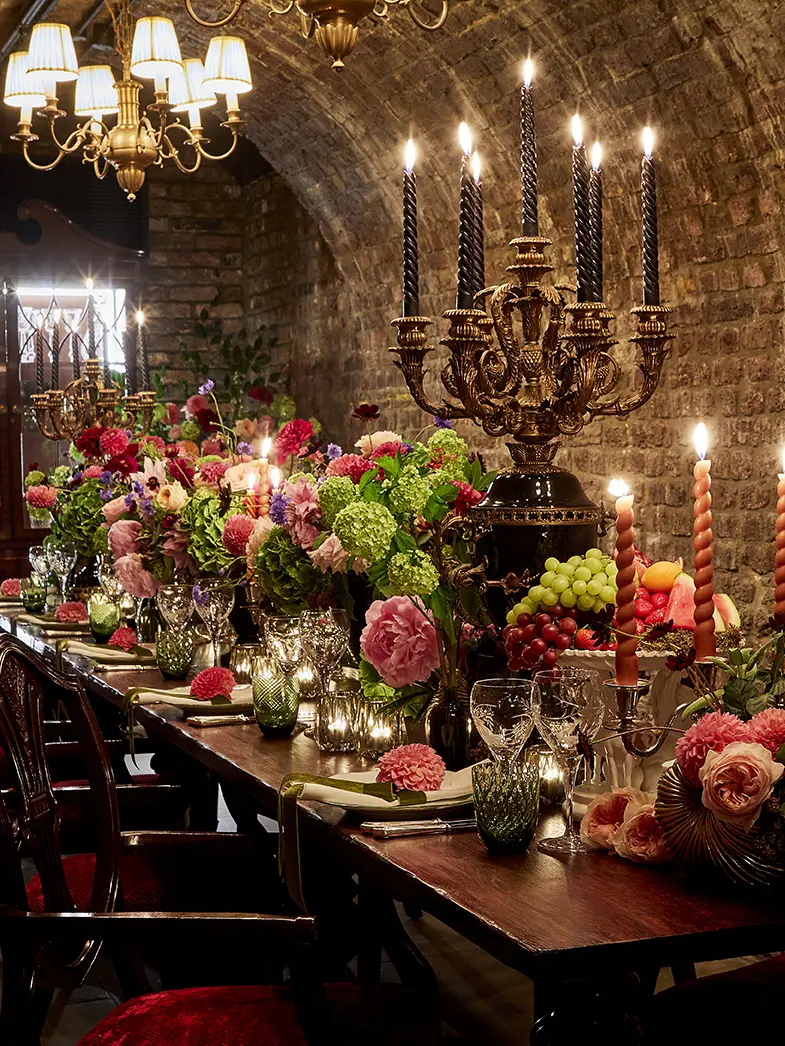 A long table filled with candles and flowers
