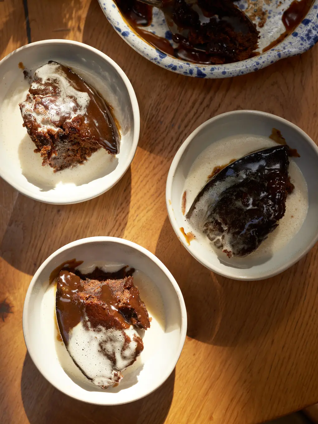 three plates of sticky toffee pudding