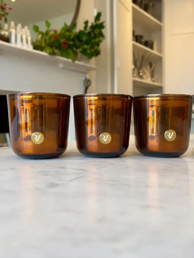 Trio of candles in amber glass jars