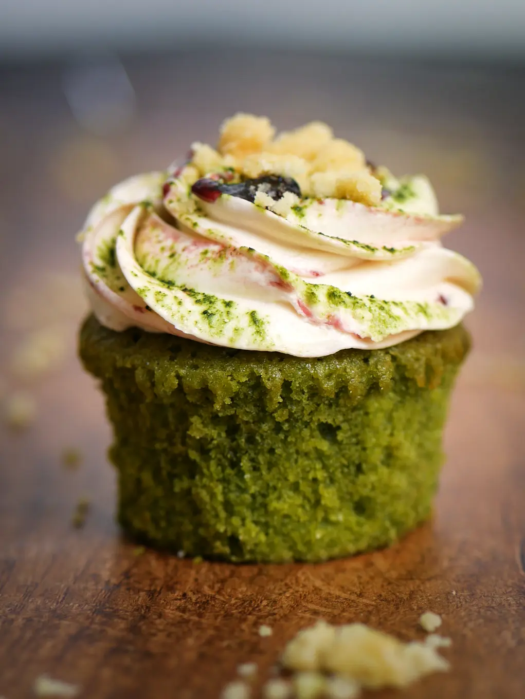 A green cupcake with icing