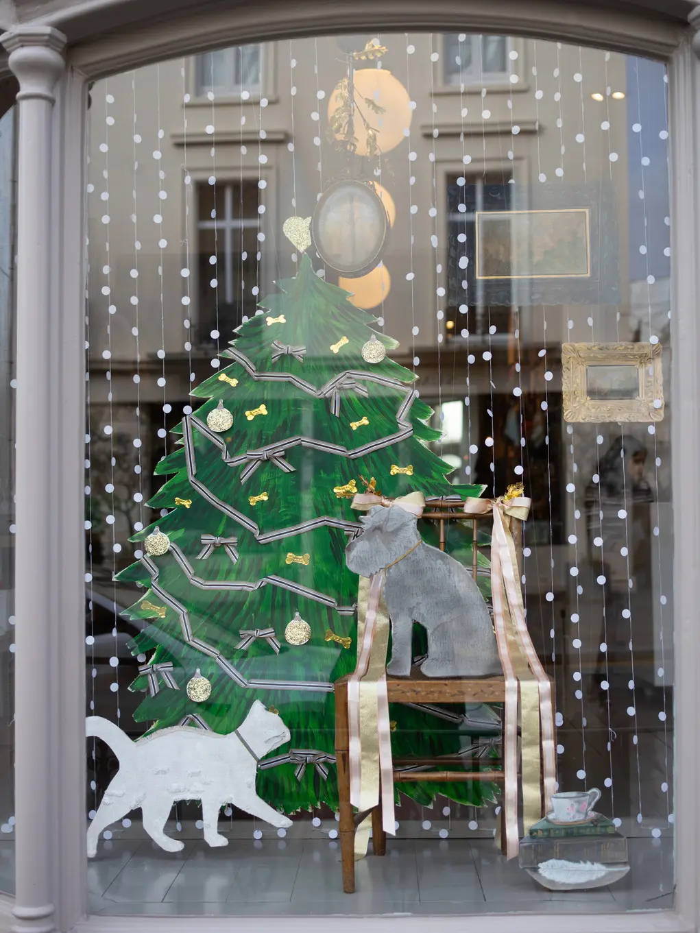 Shopfront of Pepa London with a Christmas tree and white cat display