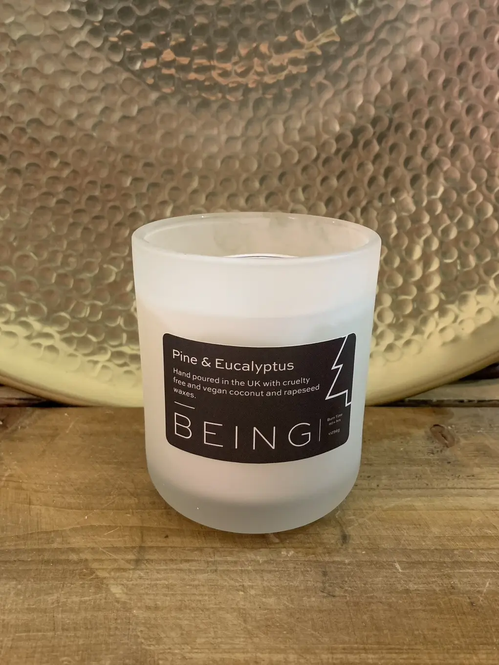 A candle in a white jar