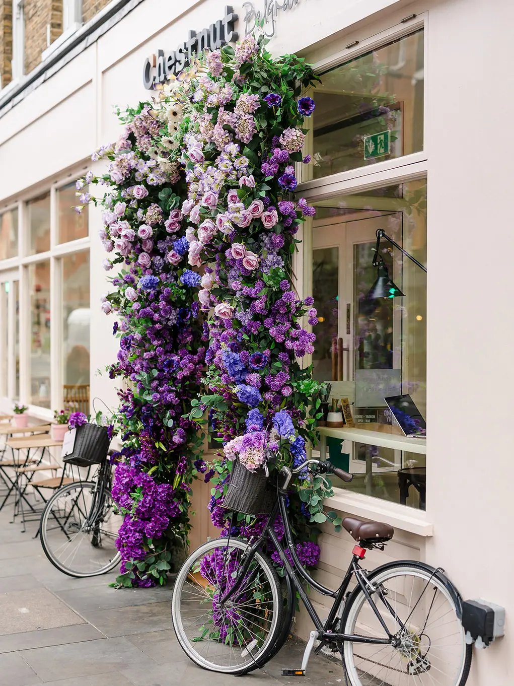 Outside of Chestnut Bakery with a floral archway and two bicycles