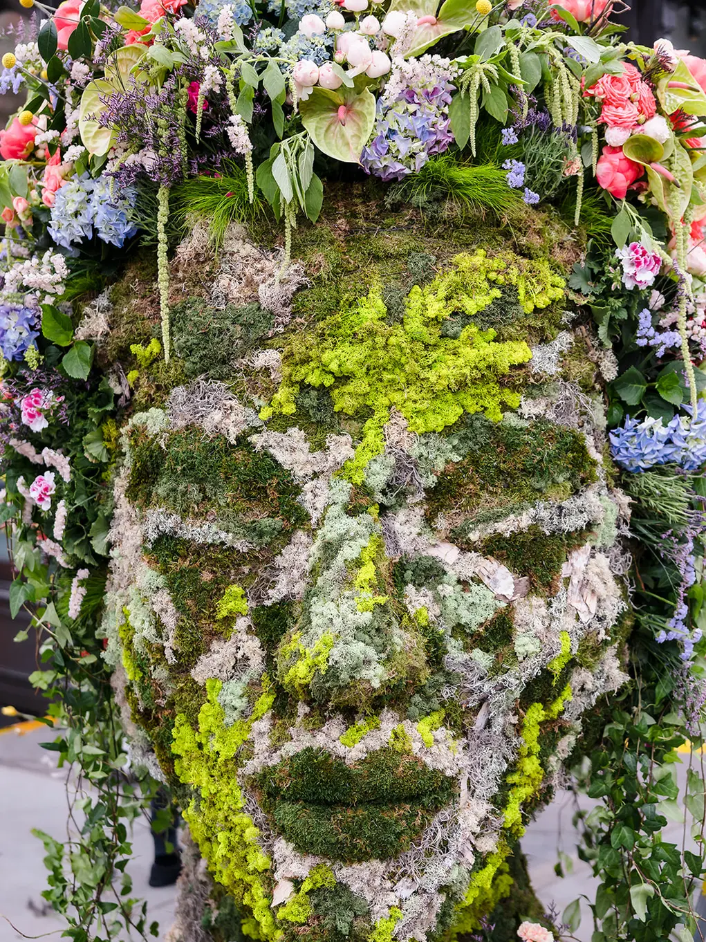 Mother Nature covered in moss and flowers