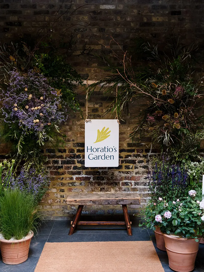 A bench surrounded by pots of flowers