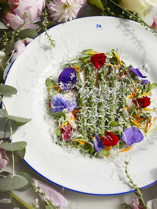 A plate of asparagus with flower decorations 
