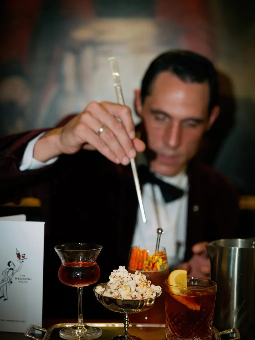 man stiring drinks