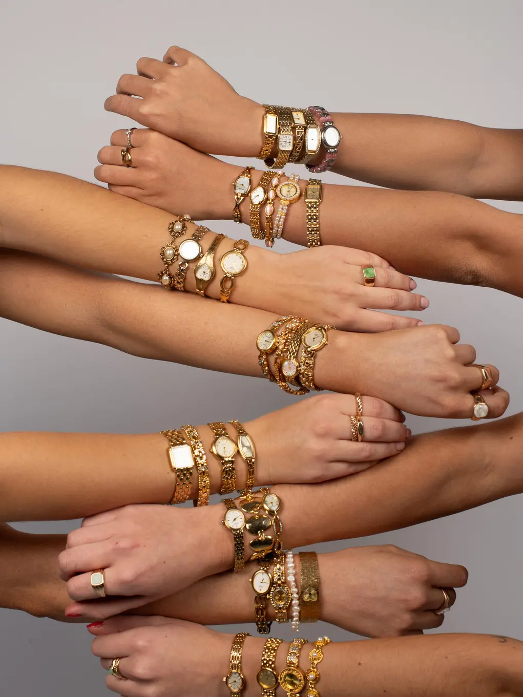 Eight hands wearing multiple watches