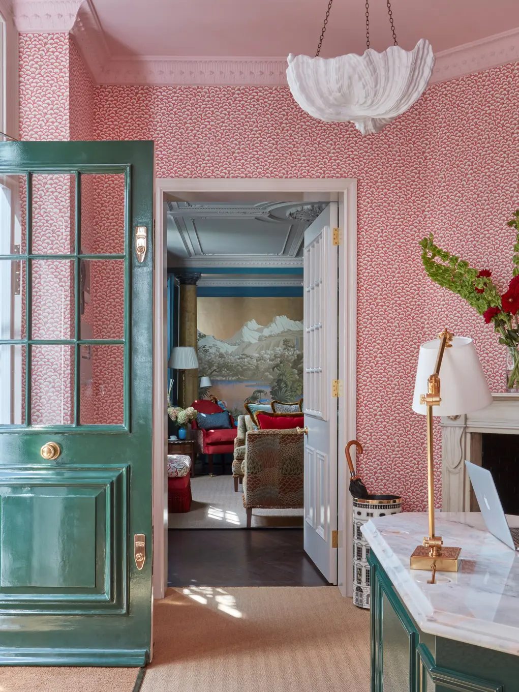 Inside Montrose with pink walls and a green door 