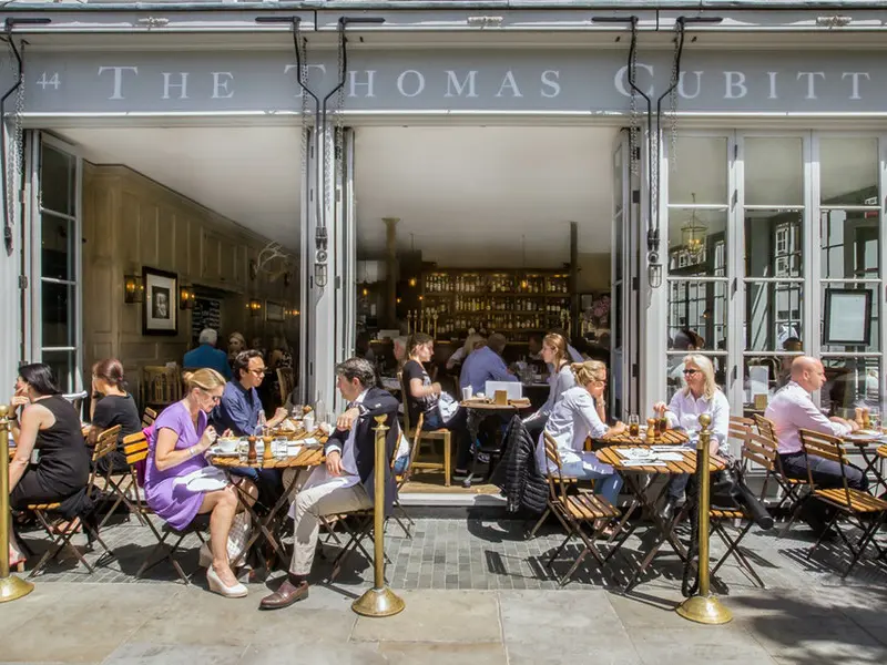 people eating outside The Thomas Cubitt pub