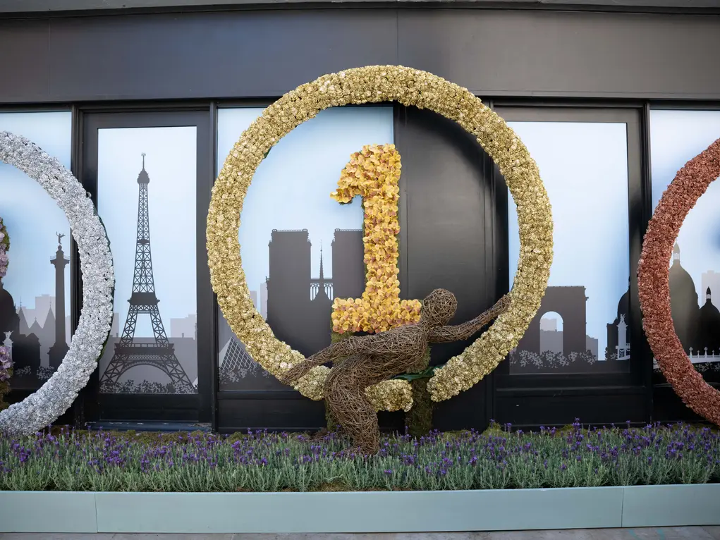 A floral display showing a person running with a number 1 in the background