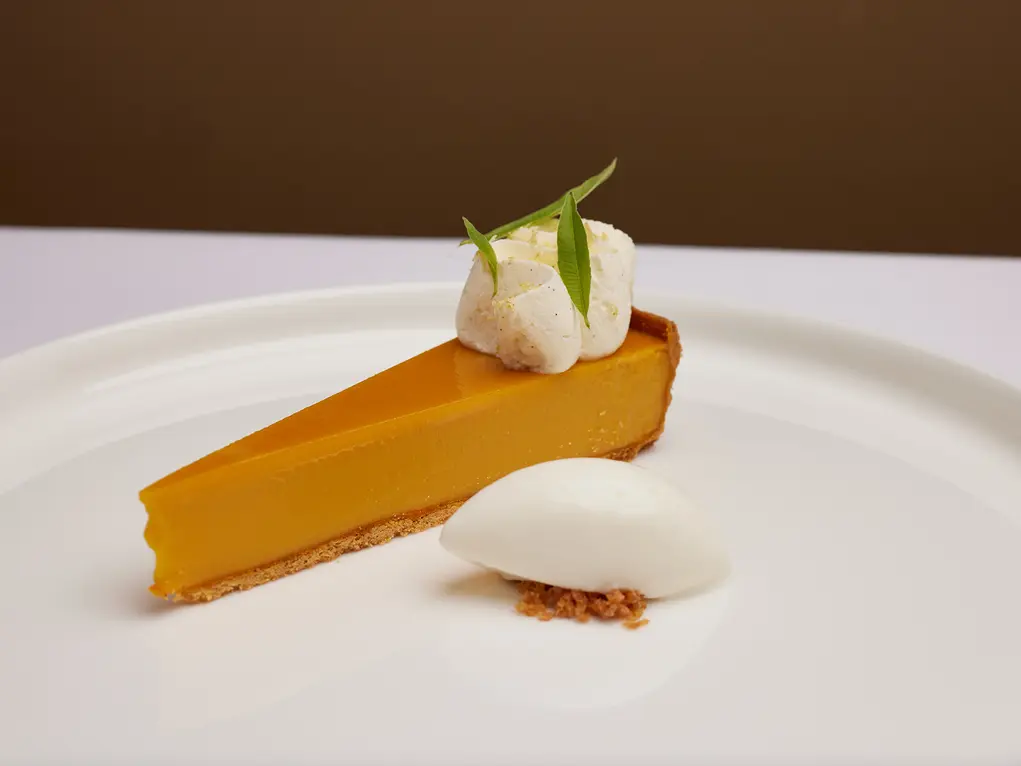A lemon tart on a white plate