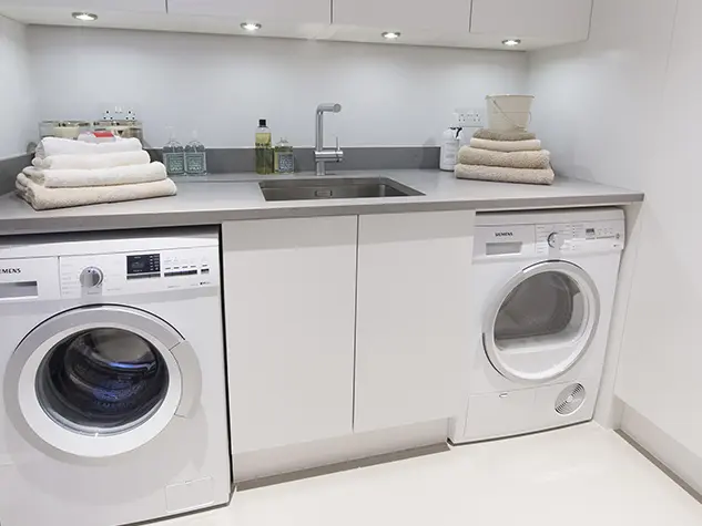 Utility room with a washing machine, sink and dryer