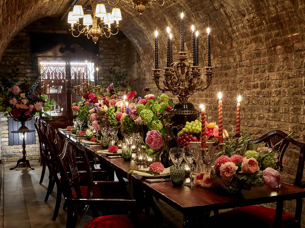 A long table filled with candles and flowers