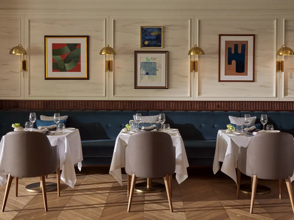 Tables in a restaurant with pictures on the wall
