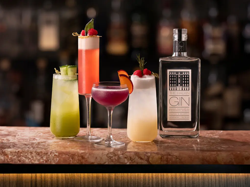 Four cocktails and a bottle of gin