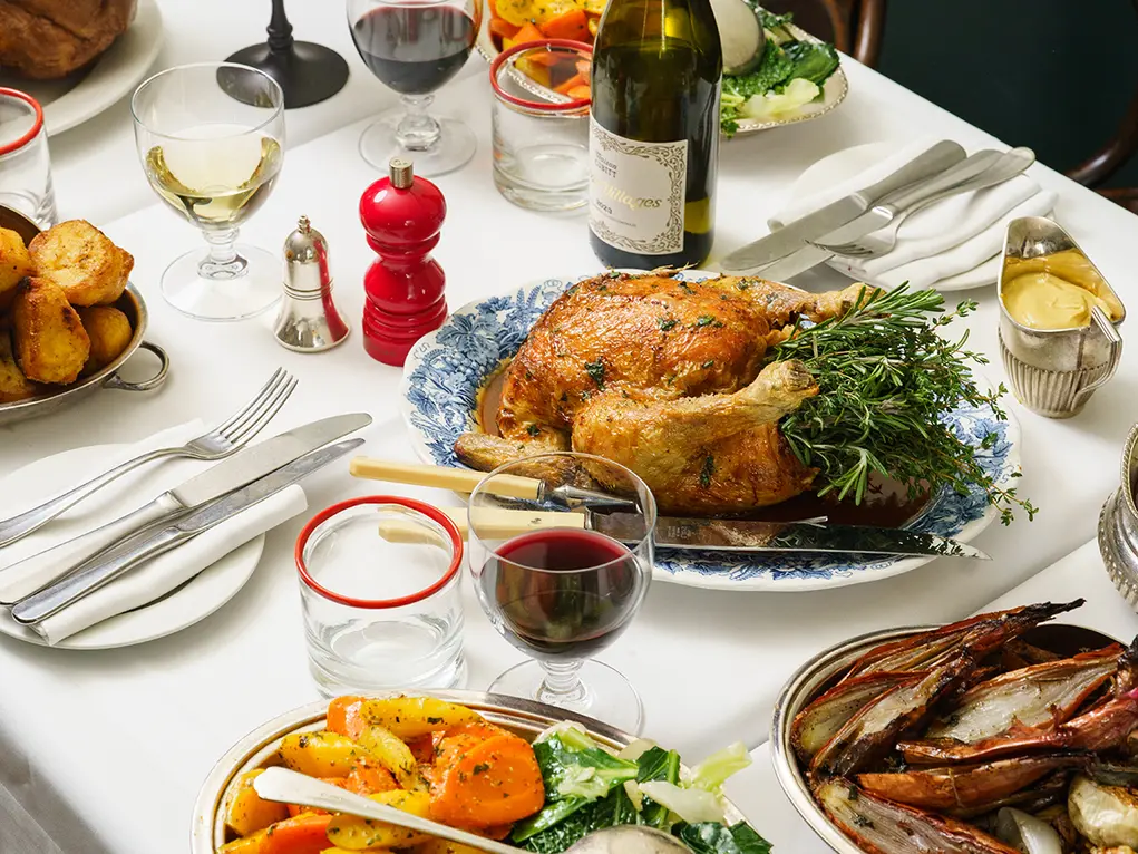A roast dinner with a bottle of wine